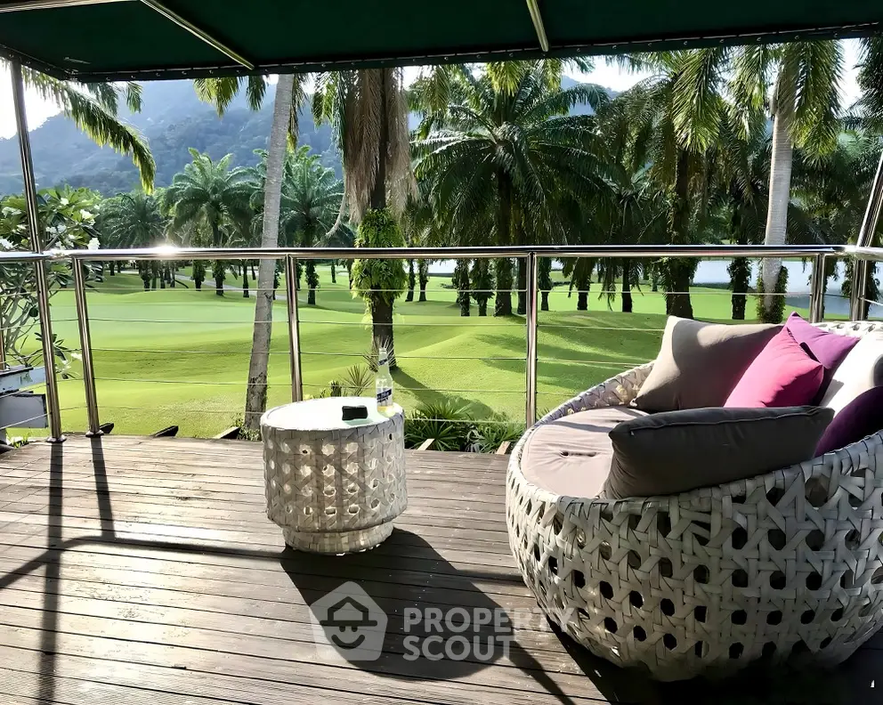 Luxurious balcony with stunning golf course view and cozy seating area