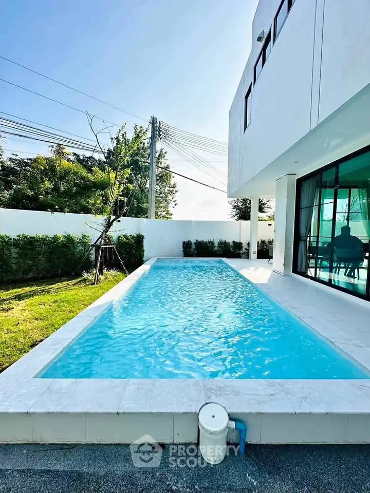 Luxurious modern home with private pool and lush garden, perfect for relaxation and entertainment.