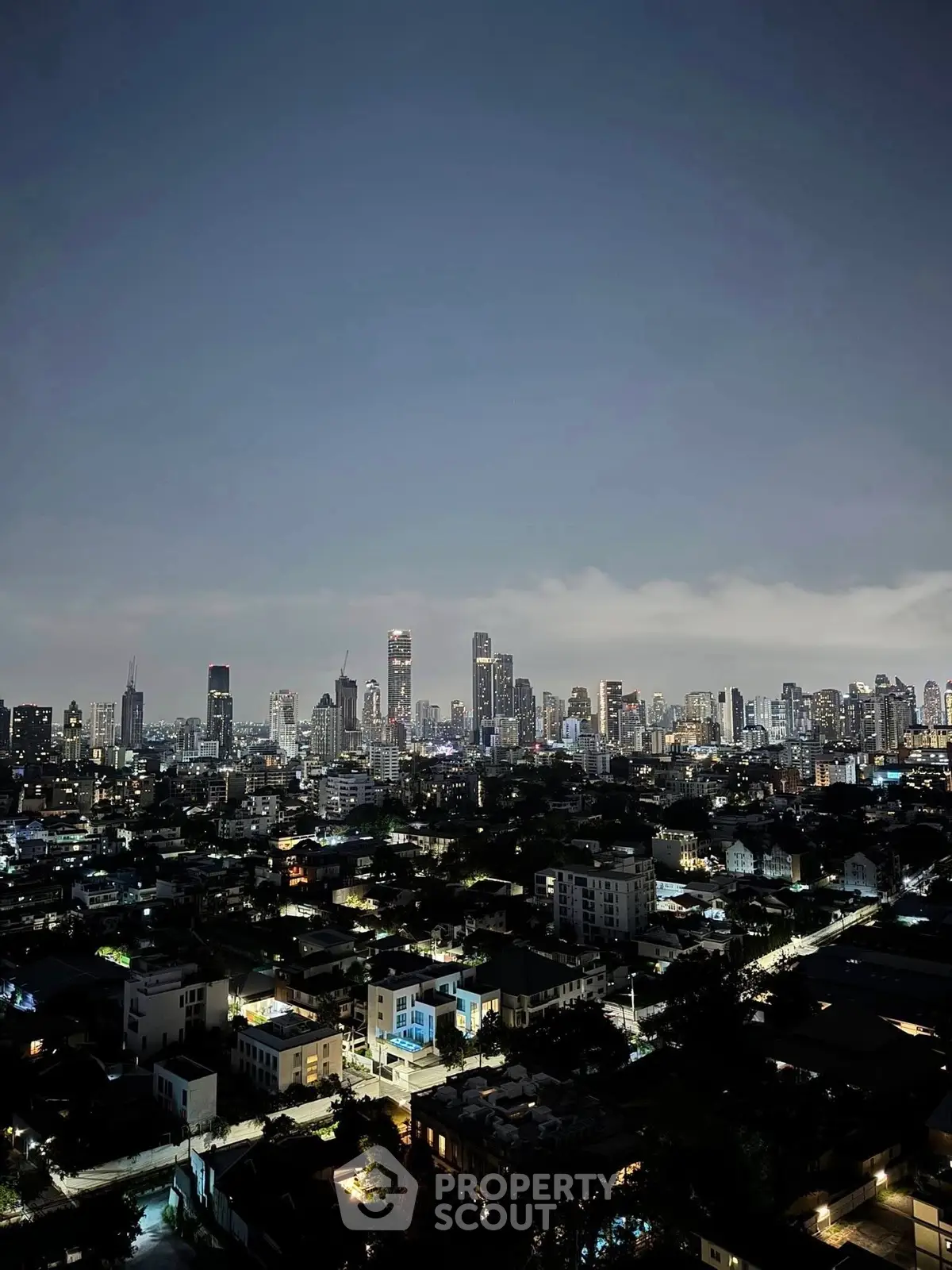 Stunning city skyline view at dusk with illuminated buildings and vibrant urban landscape.