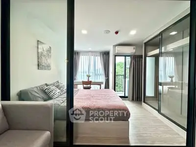Modern bedroom with glass partition and balcony view in stylish apartment