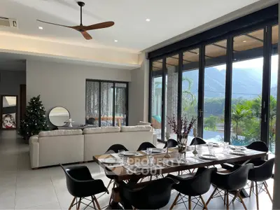 Luxurious open-plan living and dining area with stunning mountain views and modern decor.