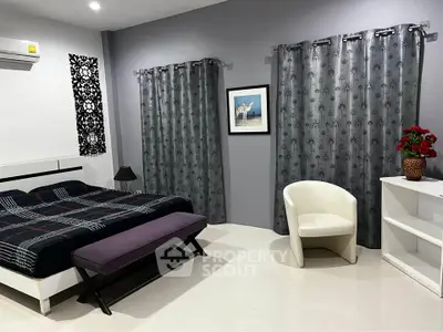 Modern bedroom with stylish decor and cozy ambiance, featuring elegant curtains and contemporary furniture.