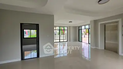 Spacious modern living area with large windows and elevator access, ideal for contemporary living.