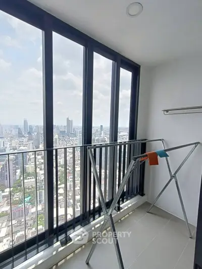 High-rise balcony with stunning city view and laundry rack