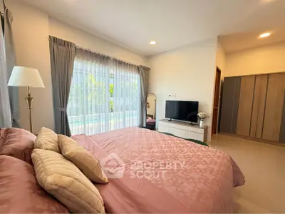 Spacious bedroom with large window and modern decor, featuring a cozy bed and stylish wardrobe.