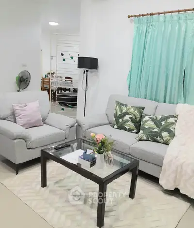 Charming living room with cozy sofas and elegant decor, perfect for relaxation and entertaining guests.