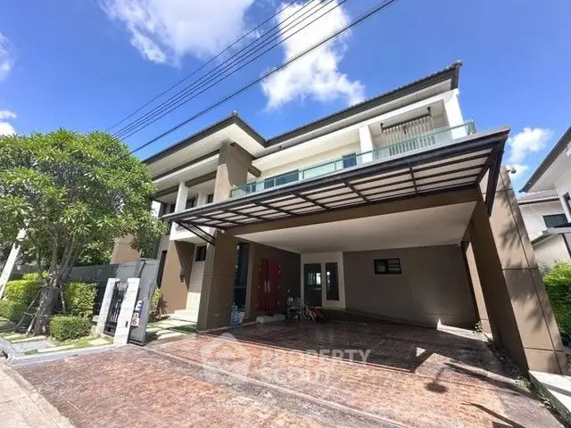 Modern two-story house with spacious driveway and lush greenery under a clear blue sky.