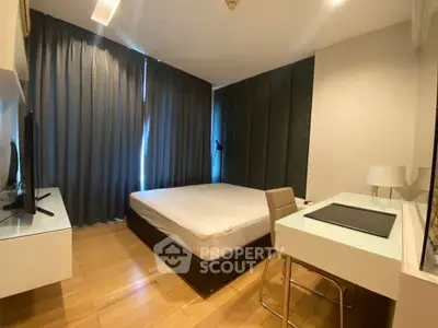 Modern bedroom with sleek design, featuring a comfortable bed, desk, and large window with curtains.