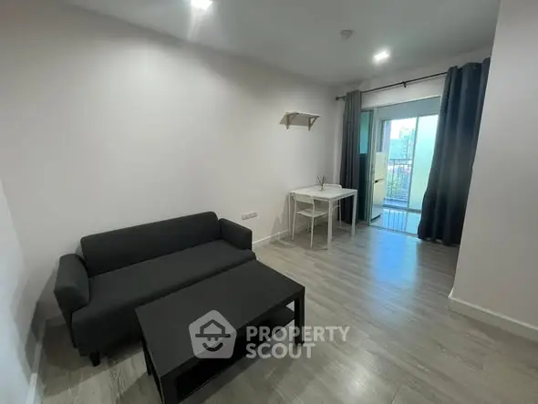 Modern living room with sleek furniture and balcony view