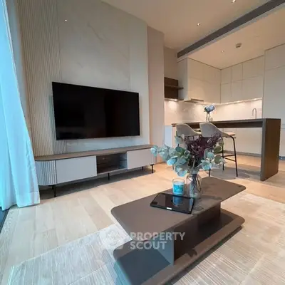 Modern living room with open kitchen, stylish decor, and sleek furniture in a contemporary apartment.