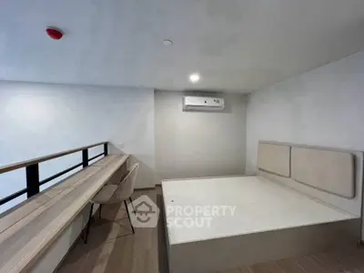 Modern minimalist bedroom with built-in desk and air conditioning, perfect for urban living.