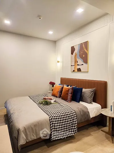 Elegant bedroom with modern decor and cozy ambiance, featuring stylish bedding and contemporary artwork.