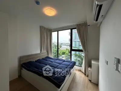Cozy bedroom with large window and modern air conditioning unit