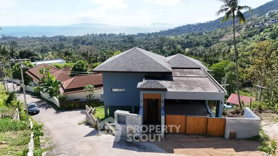 Stunning modern hillside villa with panoramic ocean views and lush greenery, perfect for luxury living.