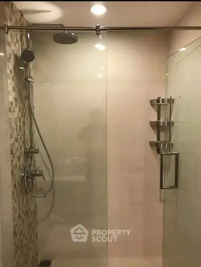 Modern bathroom with glass shower enclosure and sleek fixtures