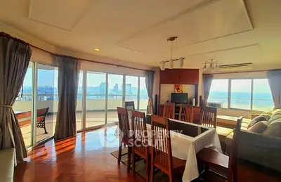 Spacious living room with panoramic city view and elegant dining area