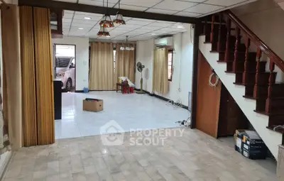 Spacious open-plan living area with staircase and natural light