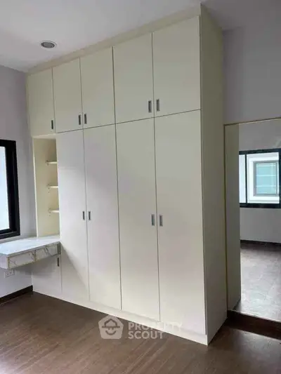 Spacious bedroom with built-in wardrobe and natural light