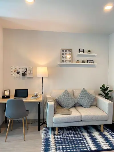 Modern living room with cozy sofa, stylish desk, and decorative shelves.