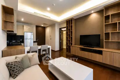 Modern living room with sleek furniture and open kitchen layout