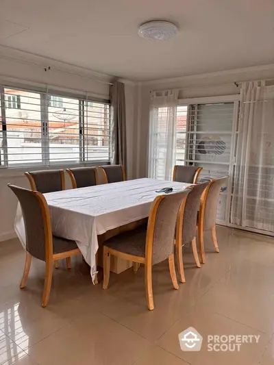 Spacious dining area with elegant table and chairs in bright room