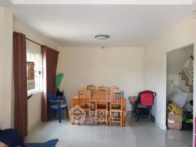 Spacious living room with dining area and natural light