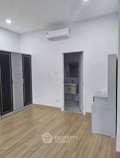 Modern bedroom with ensuite bathroom and sleek wardrobe design