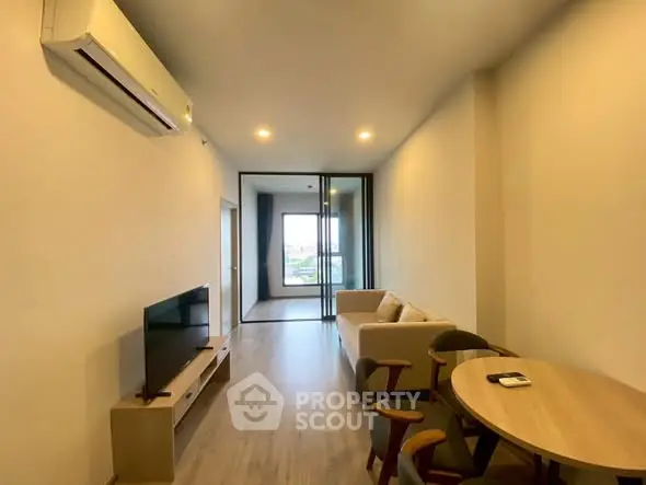 Modern living room with sleek furniture and air conditioning, offering a cozy and inviting atmosphere.