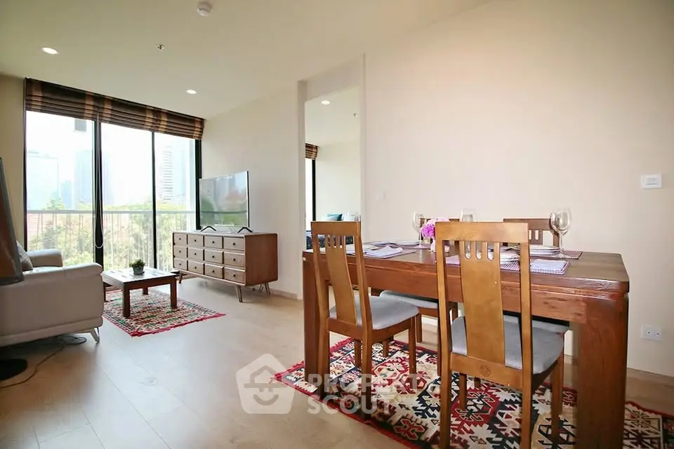 Spacious living room with dining area and large windows offering city views