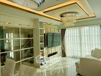Luxurious living room with elegant chandeliers and floor-to-ceiling windows