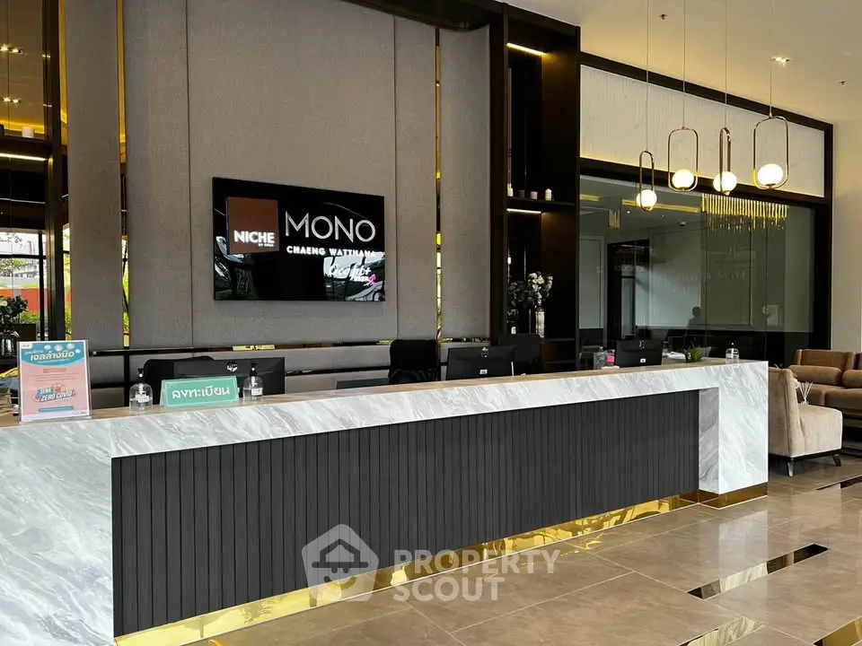 Luxurious modern lobby with elegant marble reception desk and stylish lighting fixtures.