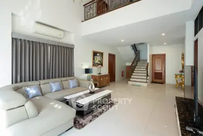 Spacious modern living room with elegant staircase and stylish decor