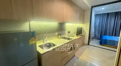 Modern kitchen with sleek cabinetry and stainless steel appliances in a stylish apartment.