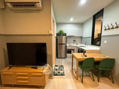 Modern open-layout kitchen and living area with stylish furniture and appliances.