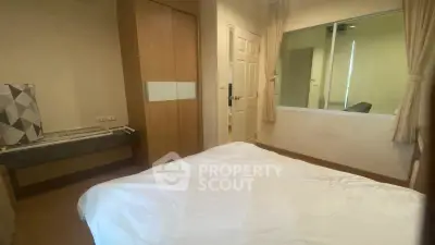 Cozy bedroom with modern decor and ample natural light