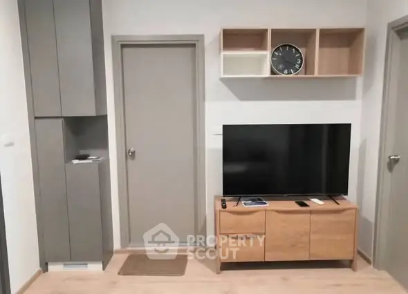Modern living room with sleek TV stand and wall-mounted storage
