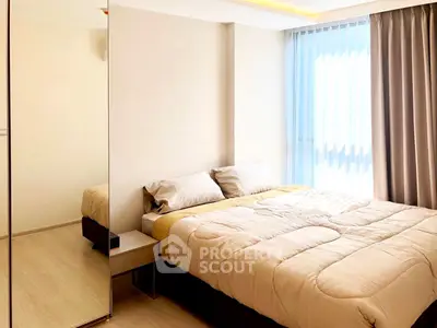 Modern bedroom with cozy bedding and large window for natural light