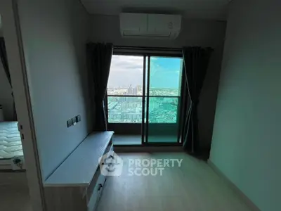 Modern bedroom with balcony view in high-rise apartment