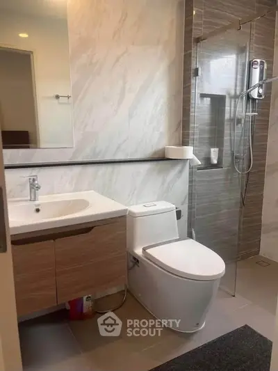 Modern bathroom with sleek fixtures and glass shower enclosure
