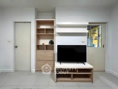 Modern living room with sleek TV stand and minimalist shelving