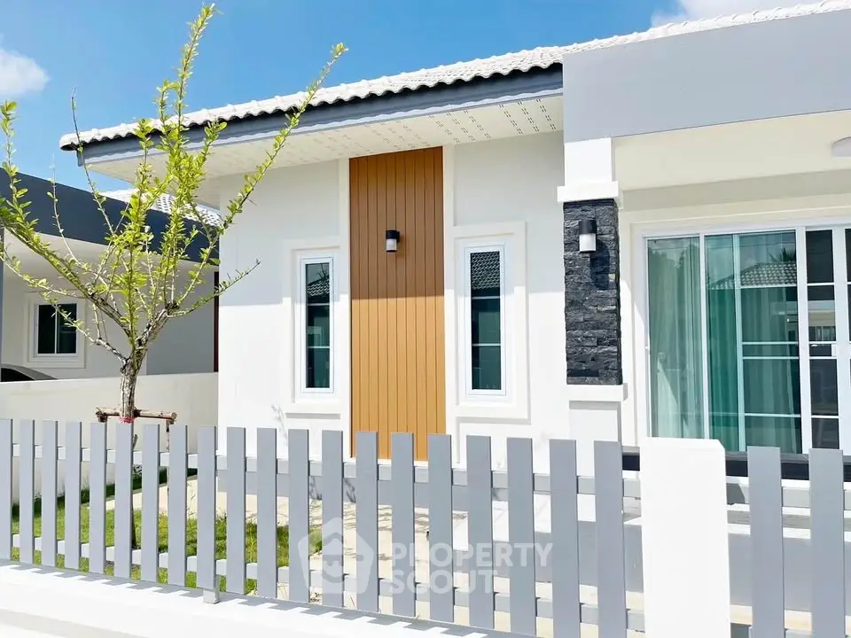 Charming modern house exterior with sleek design and fenced yard