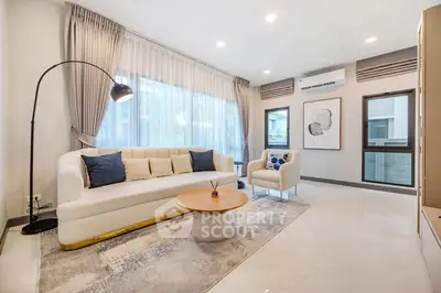 Elegant living room with modern decor and large windows