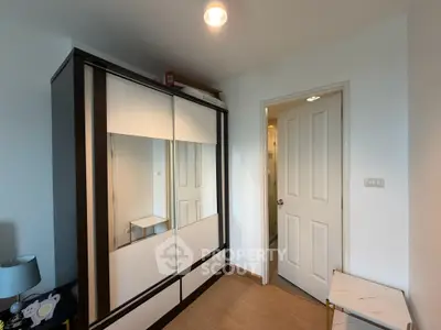 Modern bedroom with sleek wardrobe and wooden flooring, perfect for stylish living.