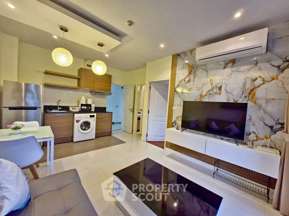 Modern open-plan living room with stylish kitchen and marble accent wall
