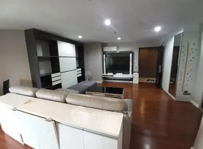 Spacious modern living room with sleek furniture and wooden flooring