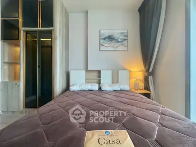 Modern bedroom with stylish decor and cozy ambiance, featuring a large bed and elegant lighting.