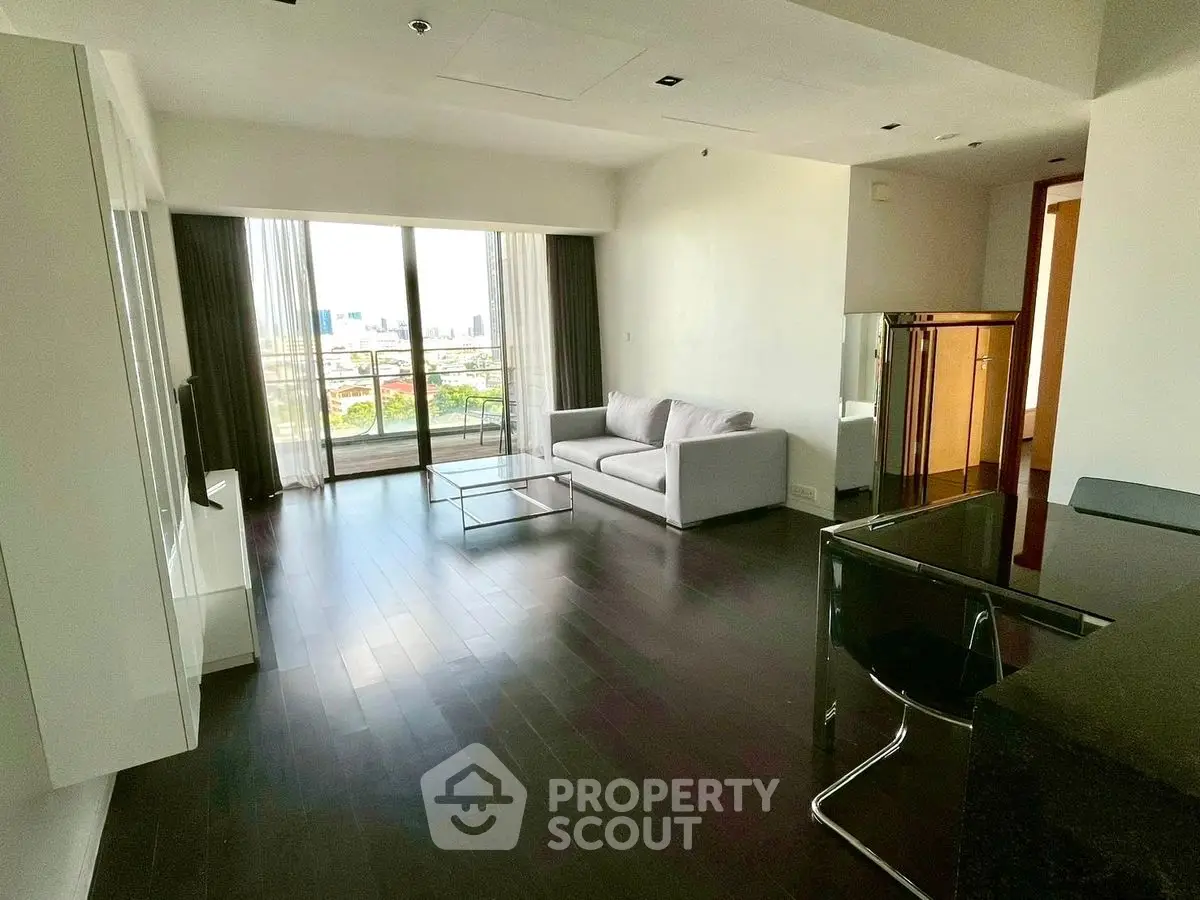 Modern living room with sleek design and city view balcony in luxury apartment.