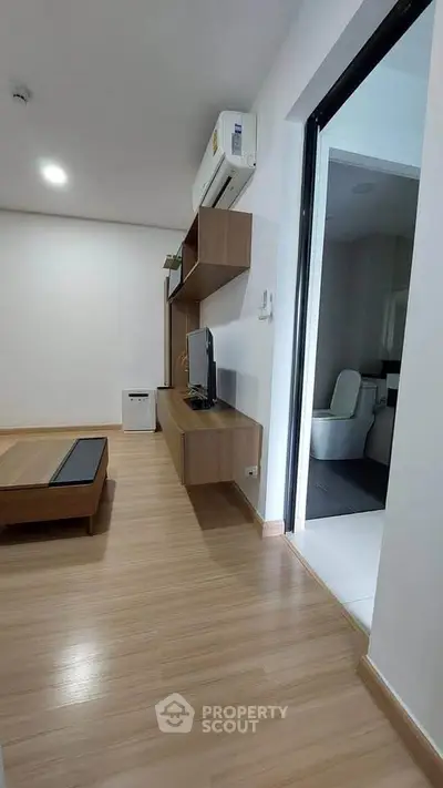 Modern apartment interior with wooden flooring and sleek furniture design