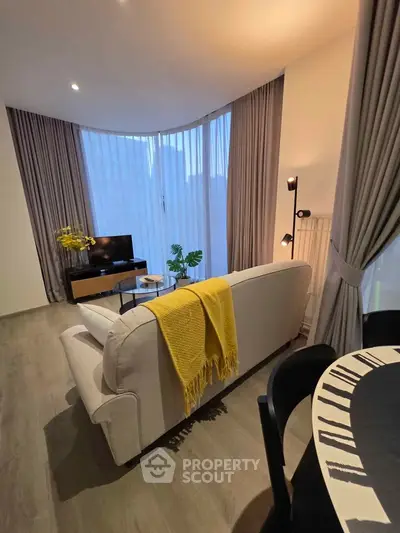 Modern living room with stylish decor and large windows in a contemporary apartment.