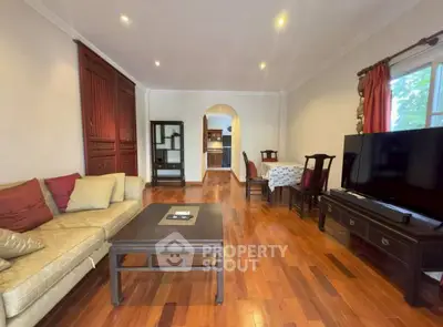 Spacious living room with elegant wooden flooring and modern furnishings